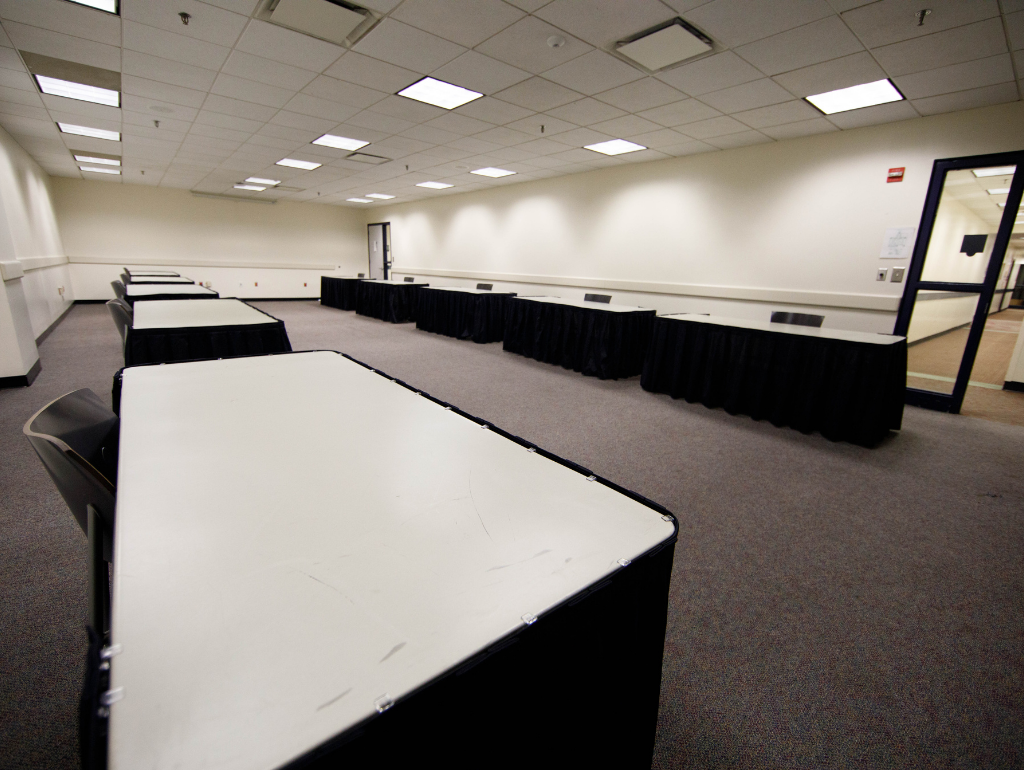 Student Center room 407 with rectangular tables lining the length of the walls, with chairs behind