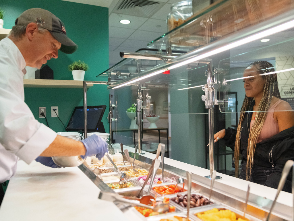  West Hall Dining. Chef serving a student at the sandwhich bar.